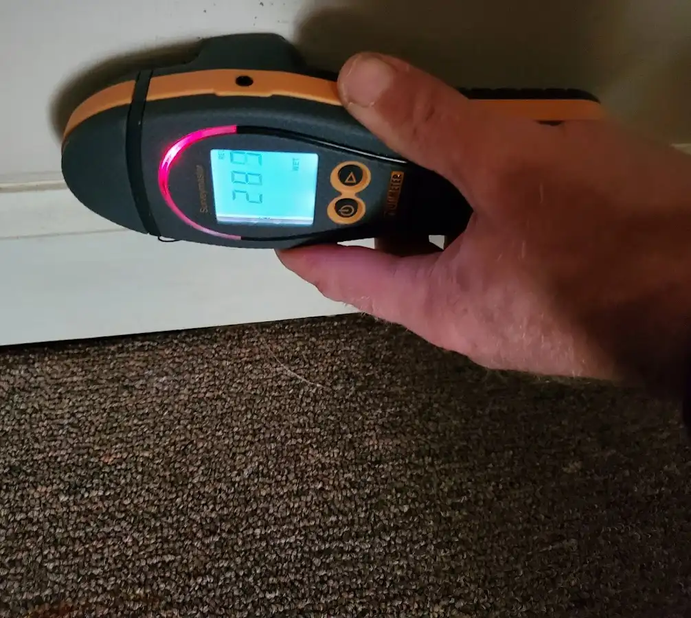 Moisture detection at baseboard during Storm Damage Restoration in Winter Garden